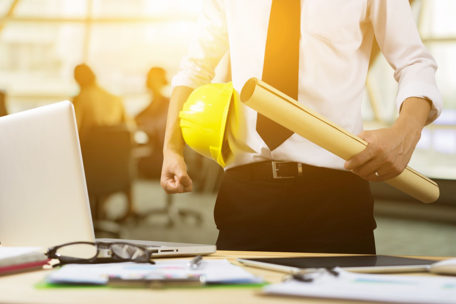 civil engineer holding plans and yellow hard hat engineering jobs